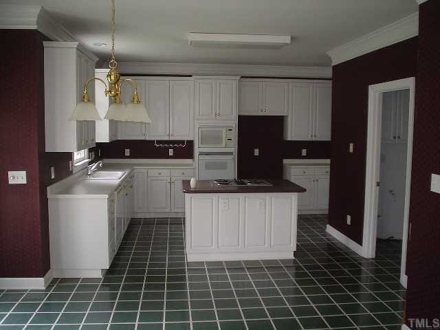 11824 Six Forks Road Raleigh, NC 27614 - Photo 3 of 4 a kitchen with a sink a stove and refrigerator