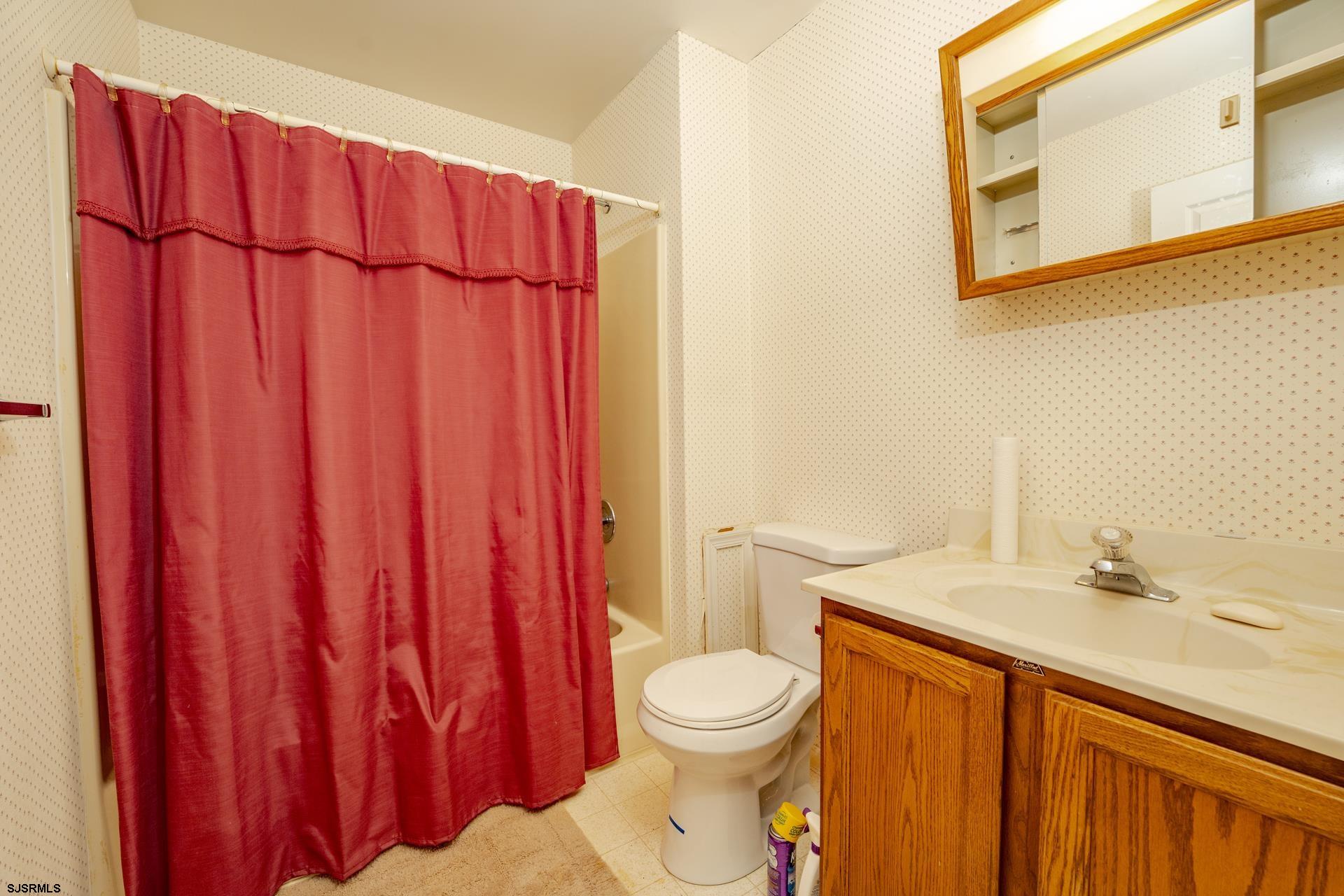 19 Clipper Court Atlantic City, NJ 08401 - Photo 13 of 53 a bathroom with a sink a toilet and shower curtain