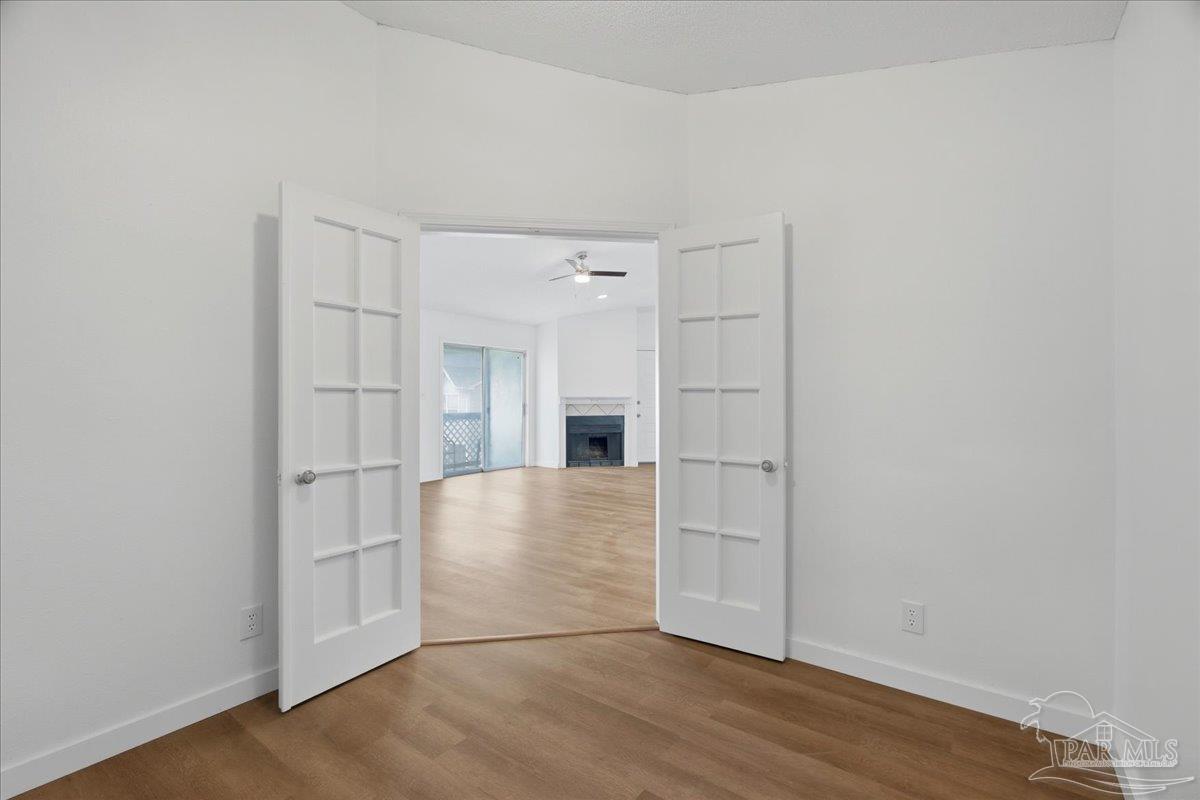 601 East Burgess Road, Unit C6 Pensacola, FL 32504 - Photo 18 of 39 a view of empty room with wooden floor and window