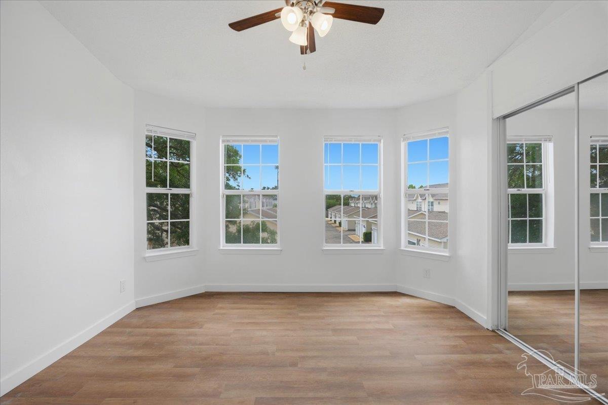 601 East Burgess Road, Unit C6 Pensacola, FL 32504 - Photo 24 of 39 wooden floor in an empty room with a window