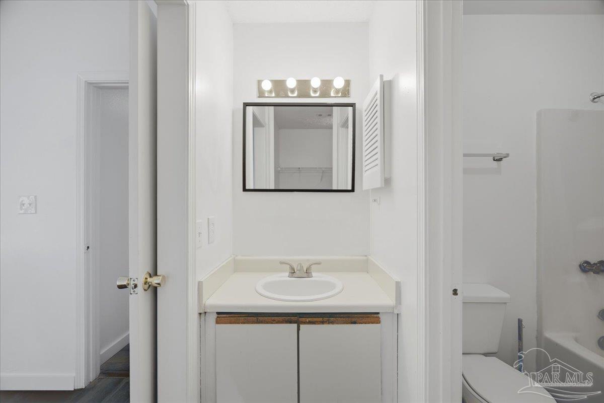 601 East Burgess Road, Unit C6 Pensacola, FL 32504 - Photo 33 of 39 a bathroom with a sink a toilet and mirror