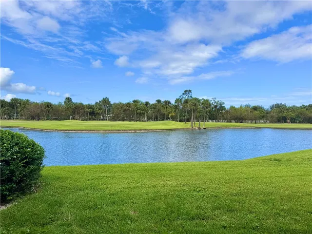 a view of a lake with houses in the back