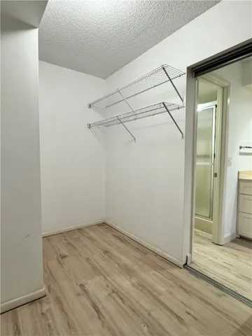 a view of a hallway view with wooden floor and cabinet