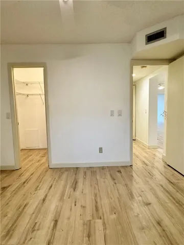 a utility room with wooden floor washer and dryer