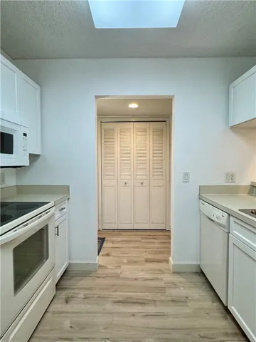 a view of a kitchen with a stove cabinets and wooden floor