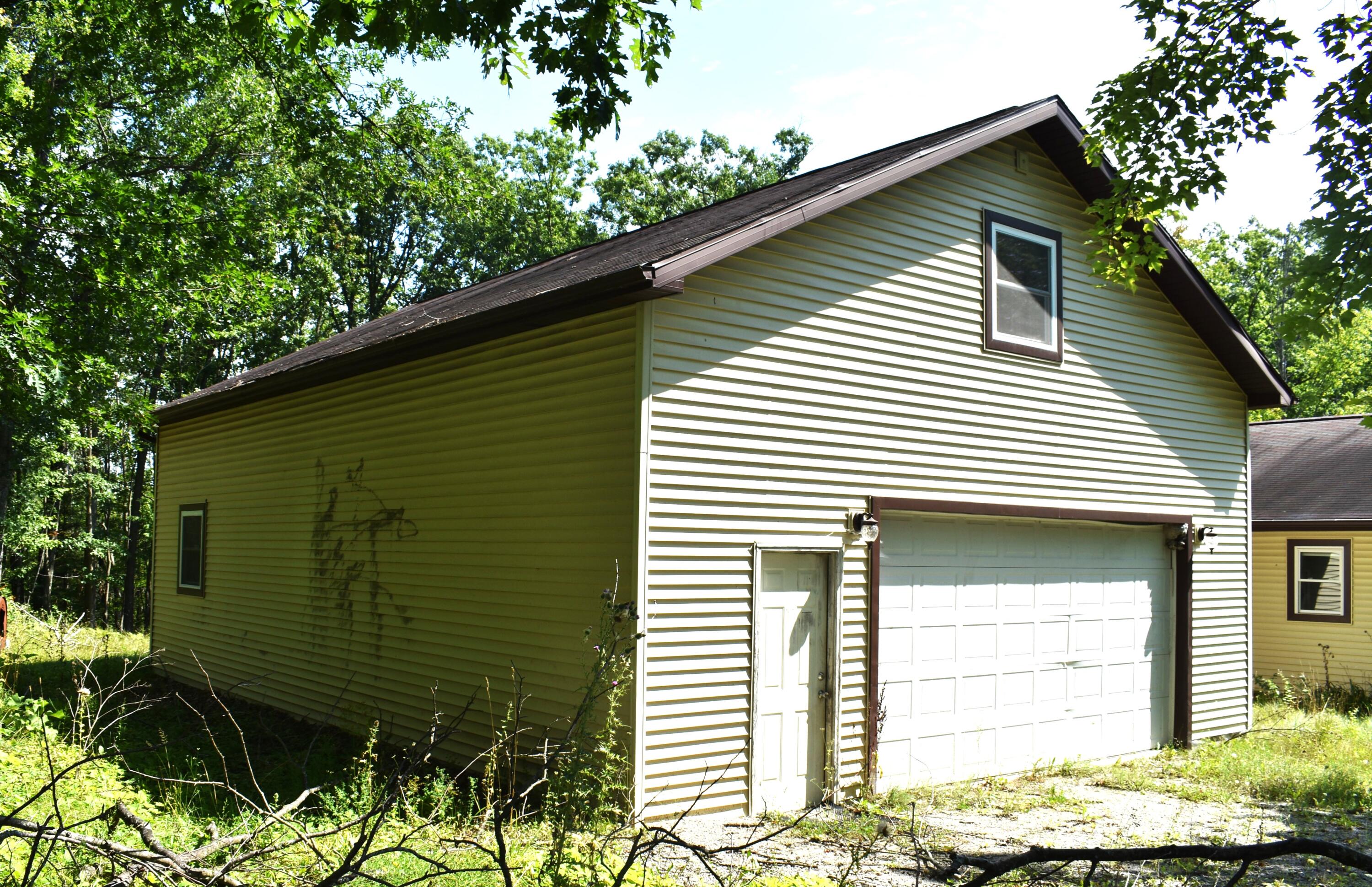 8275 Rough Road Atlanta, MI 49709 - Photo 23 of 37 Garage Exterior