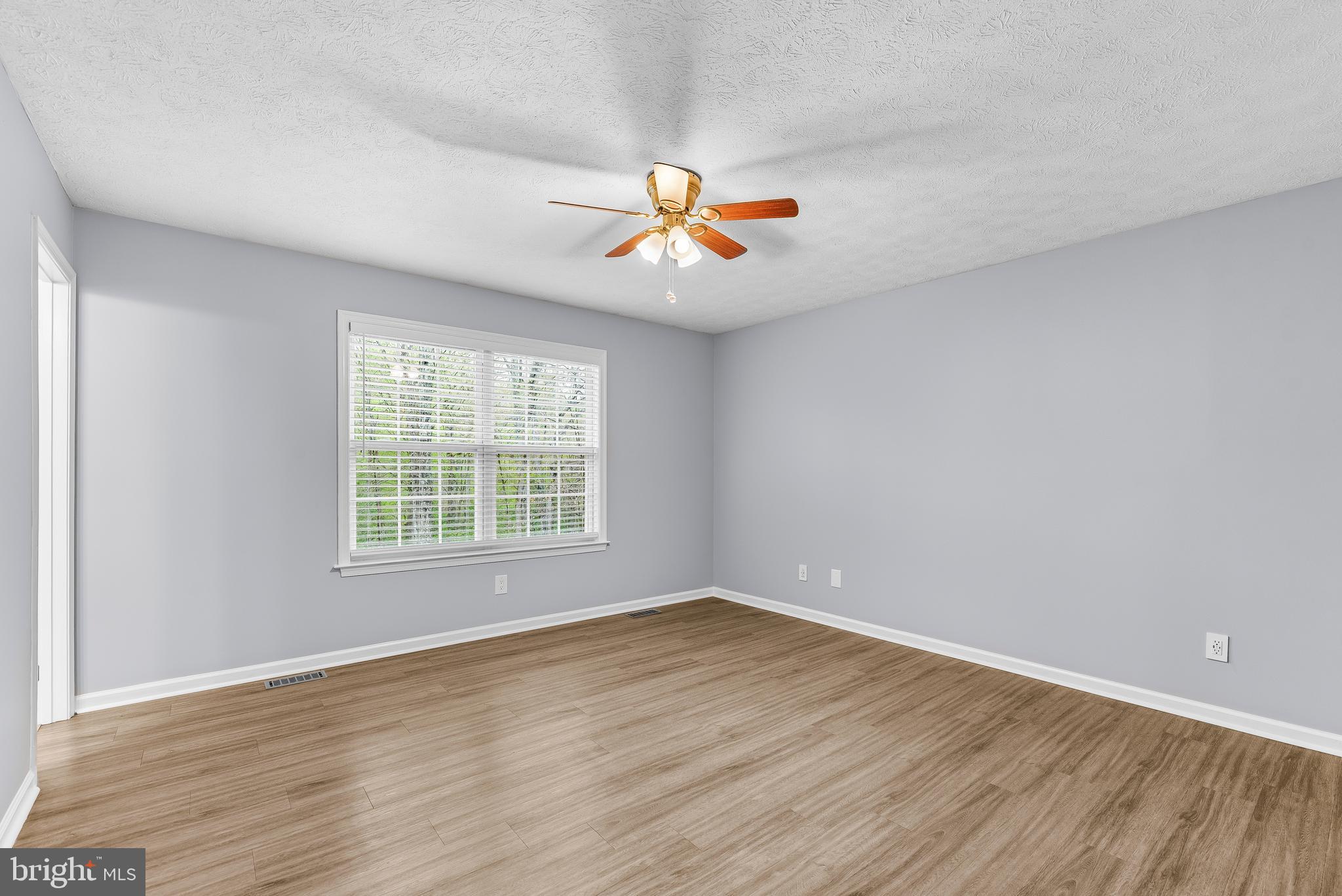 307 Red Cloud Road Lusby, MD 20657 - Photo 17 of 35 wooden floor in an empty room with a window