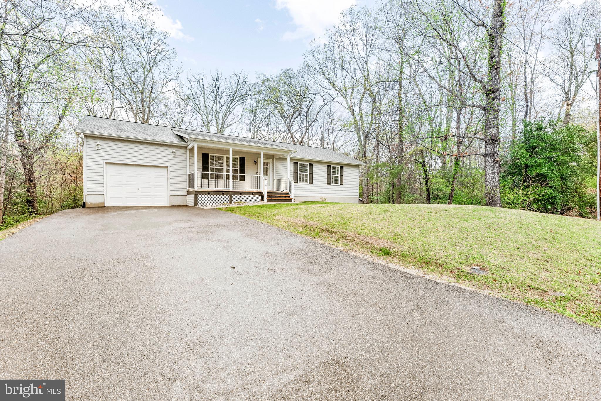 307 Red Cloud Road Lusby, MD 20657 - Photo 2 of 35 a house with trees in front of it