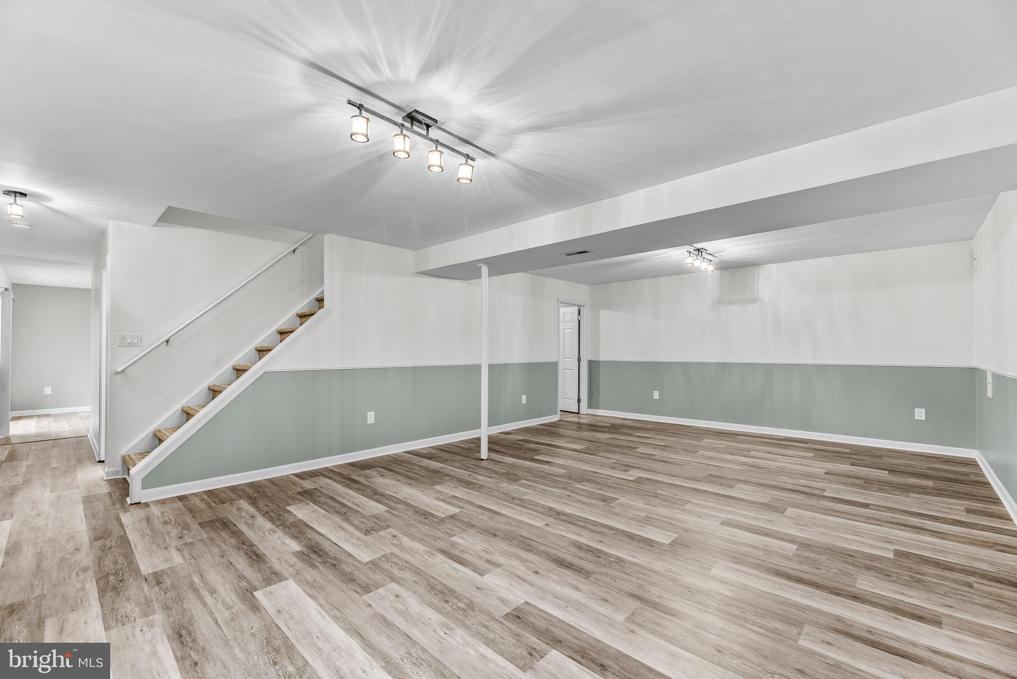 307 Red Cloud Road Lusby, MD 20657 - Photo 23 of 35 a view of an empty room with wooden floor