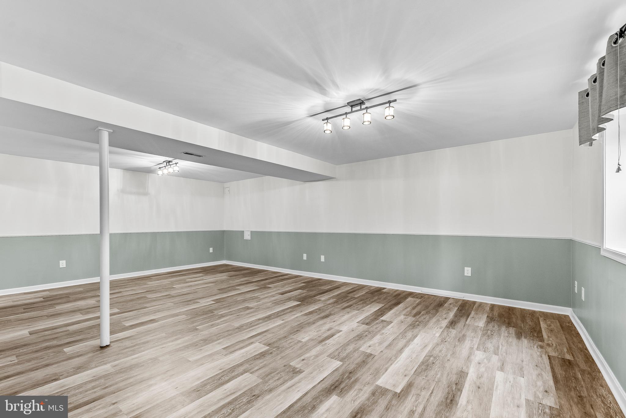 307 Red Cloud Road Lusby, MD 20657 - Photo 24 of 35 wooden floor in an empty room with a window