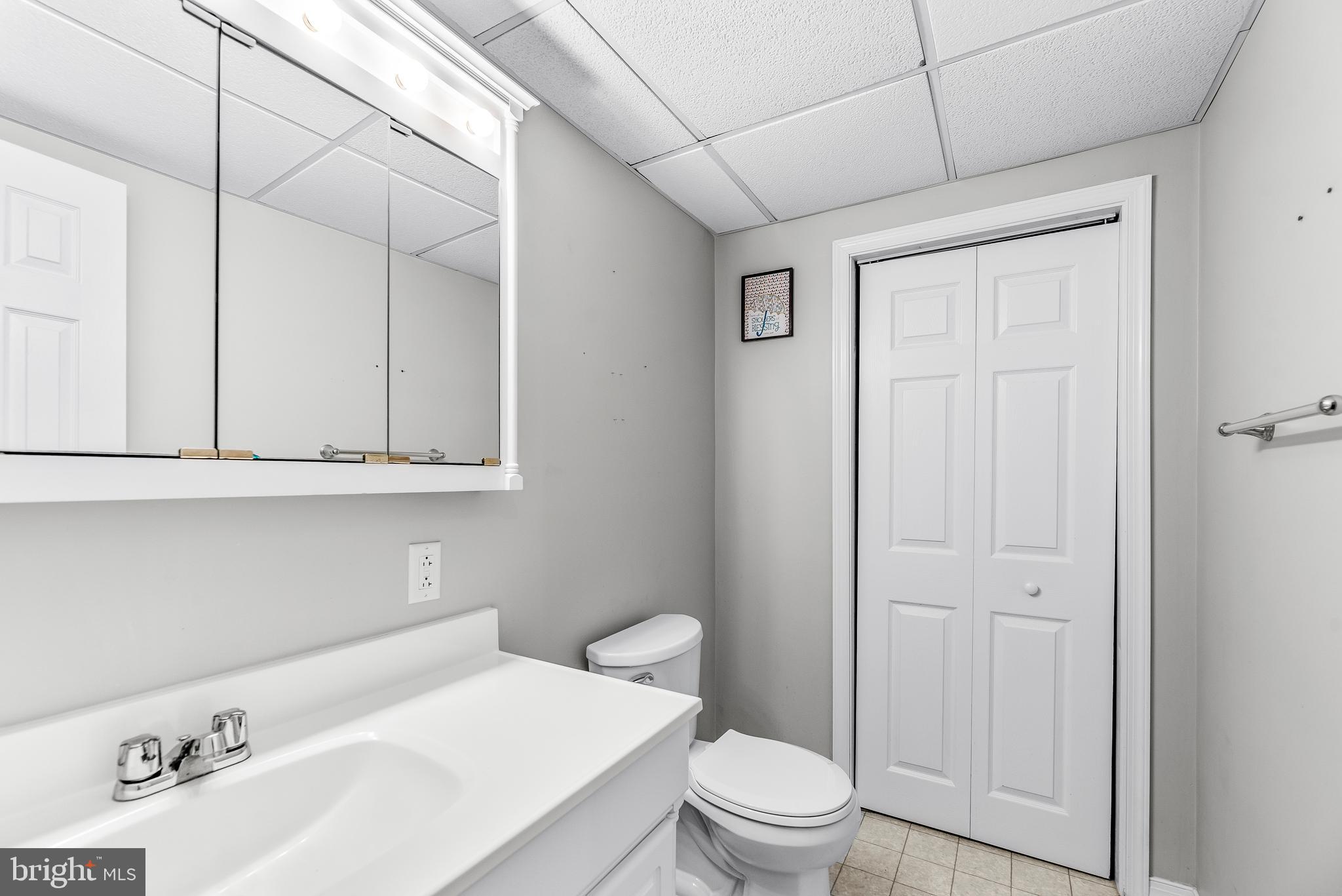 307 Red Cloud Road Lusby, MD 20657 - Photo 29 of 35 a bathroom with a sink a toilet and vanity