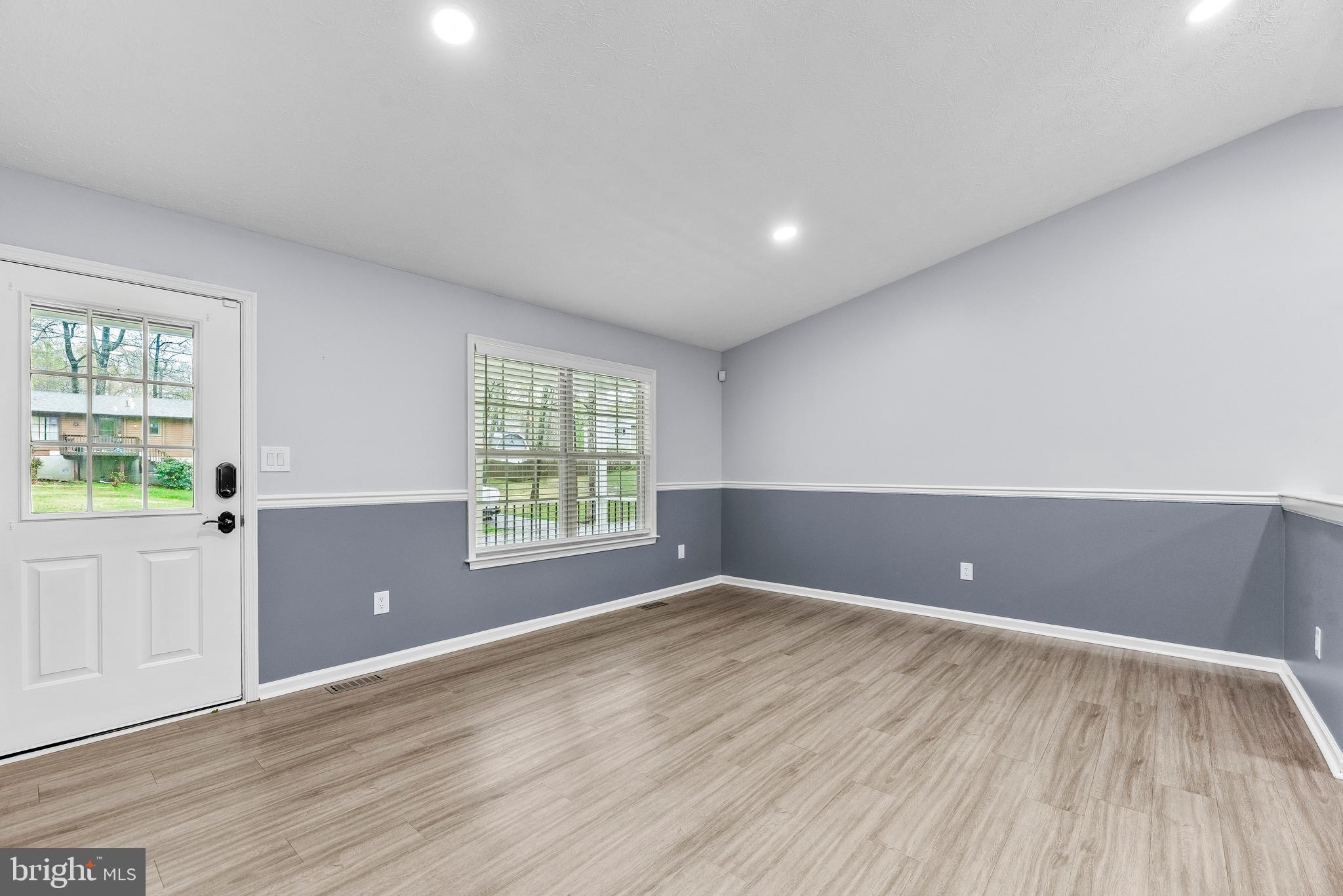 307 Red Cloud Road Lusby, MD 20657 - Photo 3 of 35 wooden floor in an empty room with a window
