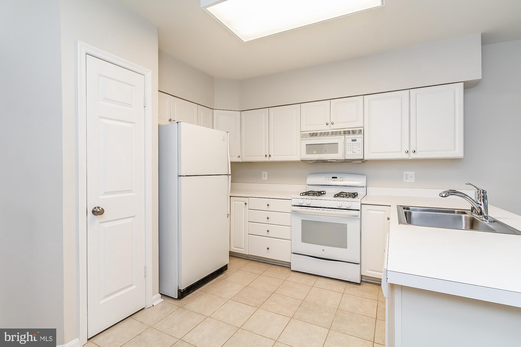 414 Rockfleet Road, Unit 201 Lutherville-Timonium, MD 21093 - Photo 9 of 35 Cheery white kitchen with pantry
