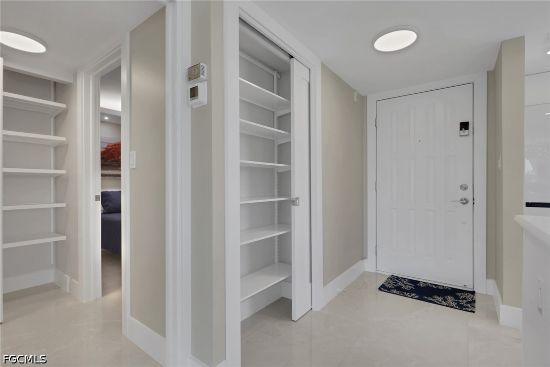 9 High Point Circle North, Unit 101 Naples, FL 34103 - Photo 13 of 49 a view of closet area with empty racks