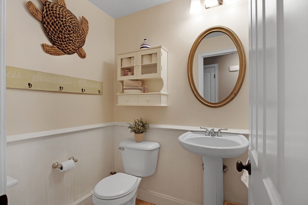 842 Main Street Wareham, MA 02571 - Photo 20 of 42 a bathroom with a toilet sink and mirror