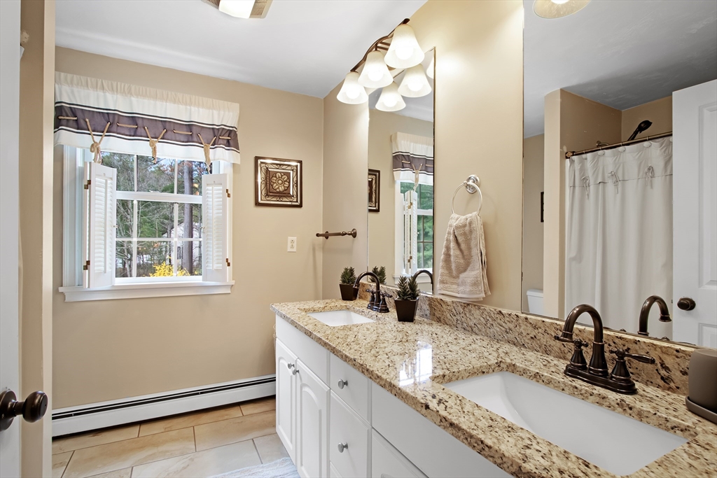 842 Main Street Wareham, MA 02571 - Photo 22 of 42 a bathroom with a granite countertop sink and a mirror