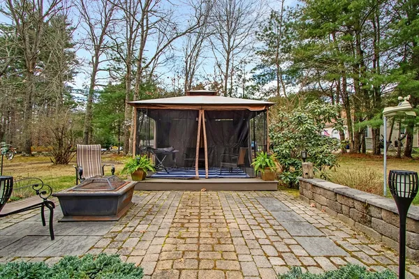 a view of a brick house with a yard and plants