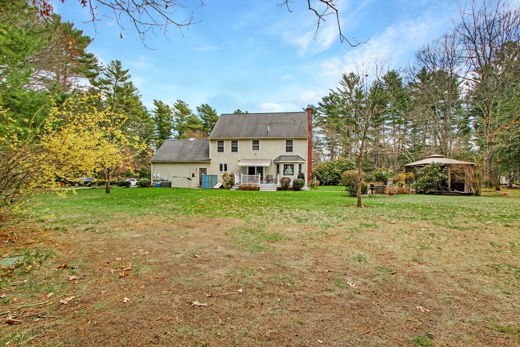 842 Main Street Wareham, MA 02571 - Photo 40 of 42 a white house with a big yard plants and large trees