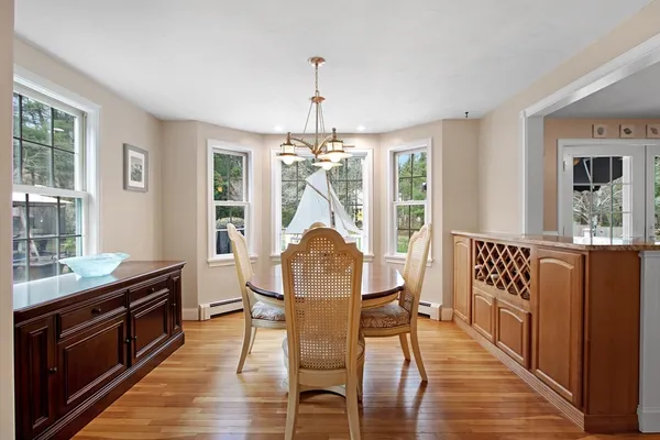a living room with furniture chandelier and a mirror