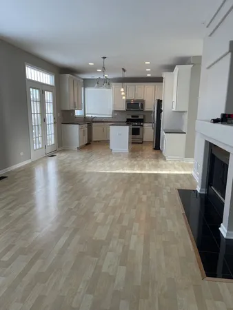 a view of kitchen with furniture and refrigerator