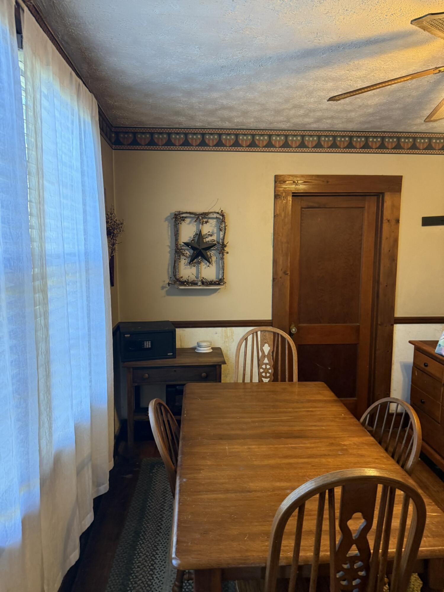 1708 Midland Trail Covington, VA 24426 - Photo 13 of 21 a bedroom with a bed and a table with wooden floor