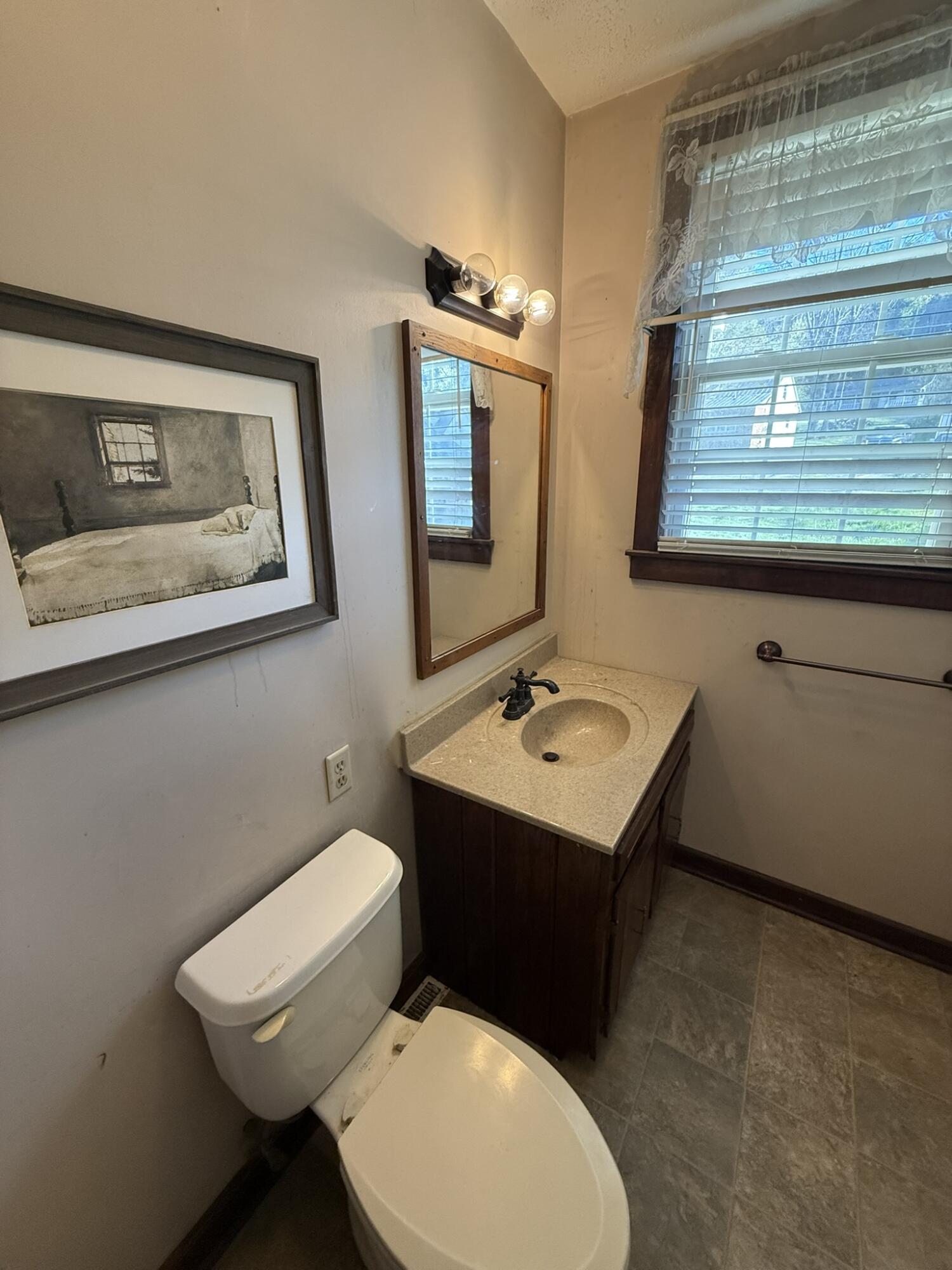 1708 Midland Trail Covington, VA 24426 - Photo 20 of 21 a bathroom with a toilet sink and mirror