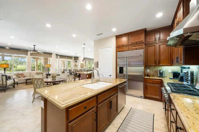 a kitchen with stainless steel appliances granite countertop a sink stove and cabinets