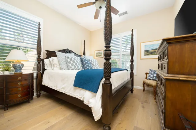 a bed room with a bed window and a potted plant