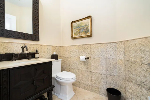 a bathroom with a toilet sink a mirror and shower