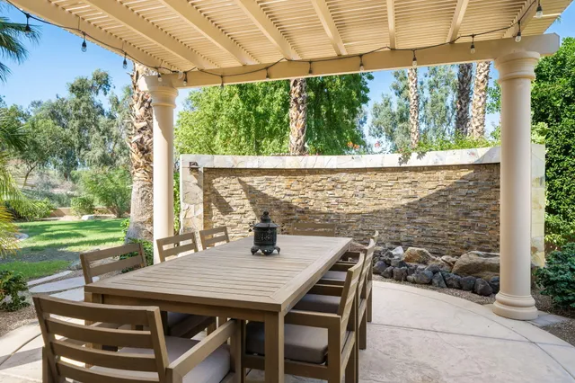 a view of an outdoor dining space with a table and chairs