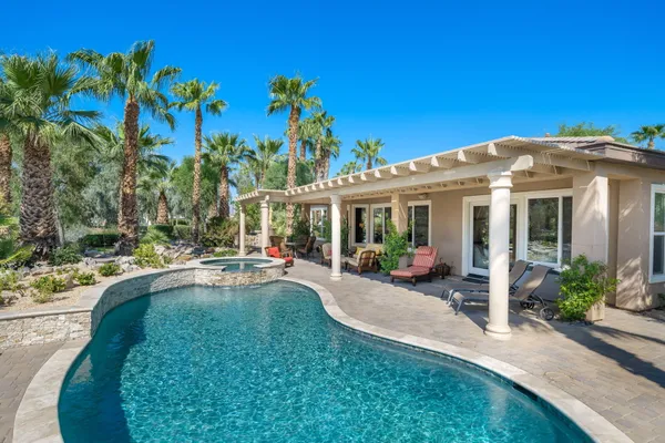 a view of a house with backyard sitting area and porch
