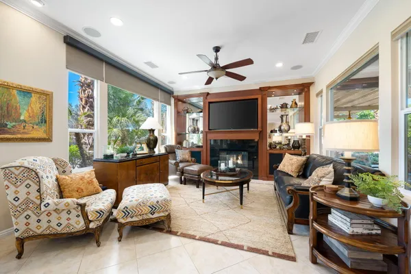 a living room with furniture fireplace and a large window