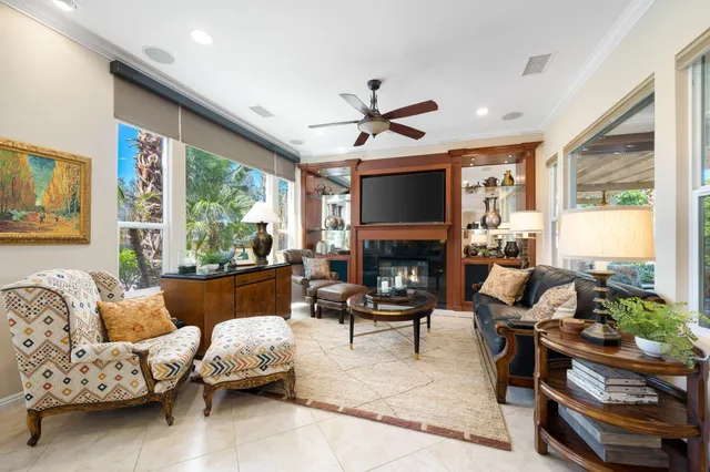 a living room with furniture fireplace and a large window