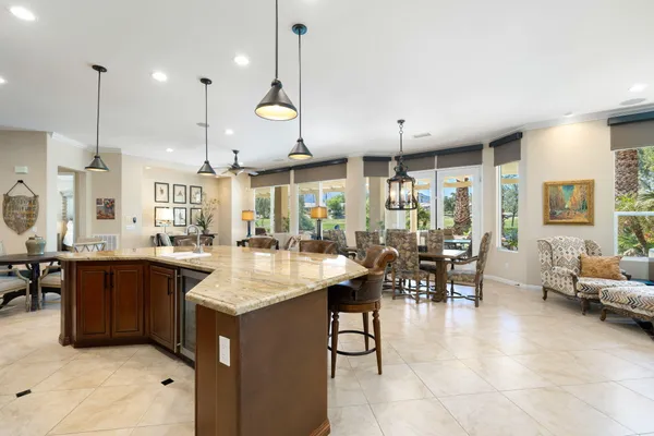 a large kitchen with lots of counter space and furniture