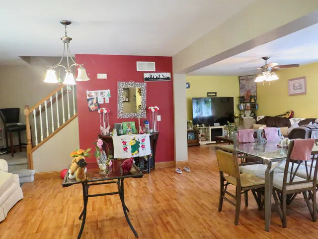 a view of a dining room with furniture and wooden floor