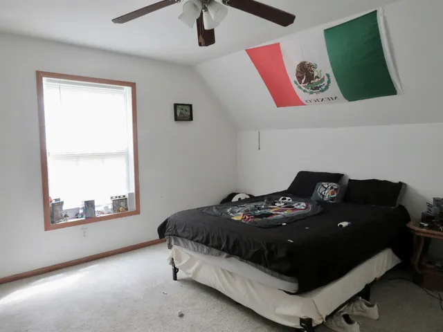 a bedroom with furniture and a window