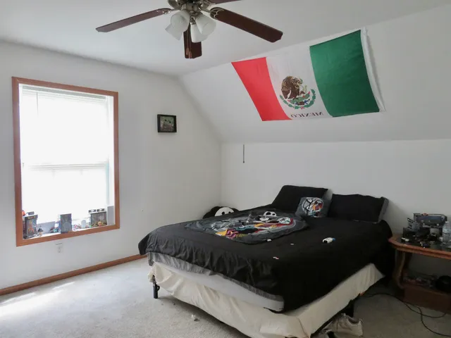 a bedroom with a bed and window
