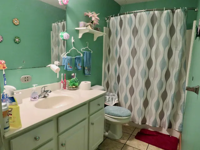 a bathroom with a sink mirror and toilet