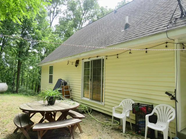 a view of a yard with plants and trees