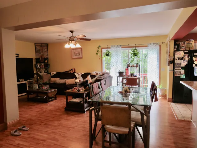 a view of a dining room with furniture window and wooden floor