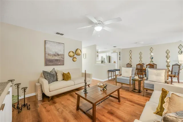 a living room with furniture and wooden floor