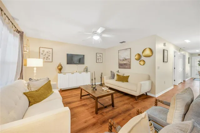 a living room with furniture and wooden floor