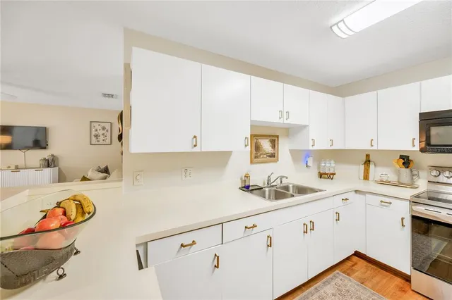 a kitchen with stainless steel appliances granite countertop a sink and cabinets