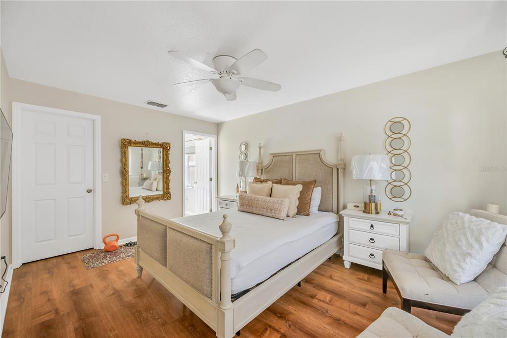 10318 Summerview Circle Riverview, FL 33578 - Photo 29 of 39 a bedroom with a large bed and a chandelier