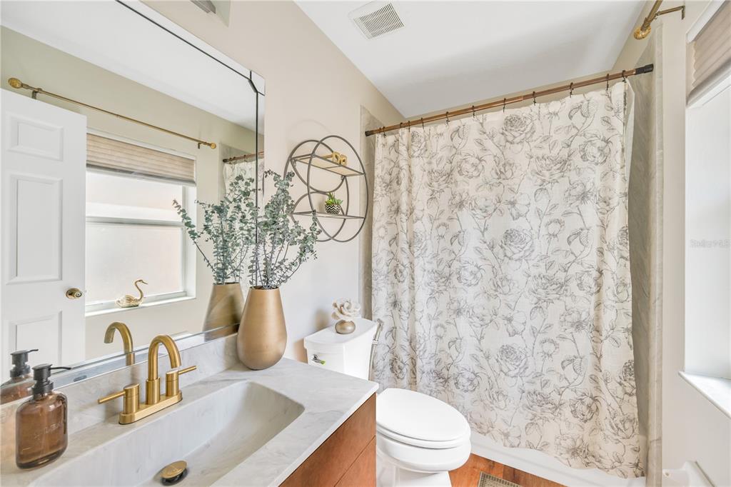 10318 Summerview Circle Riverview, FL 33578 - Photo 31 of 39 a bathroom with a sink a toilet and shower curtain
