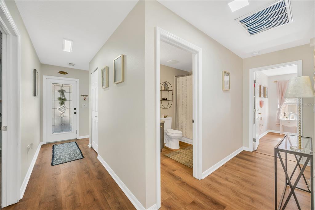 10318 Summerview Circle Riverview, FL 33578 - Photo 32 of 39 a view of a hallway with wooden floor and dining room view