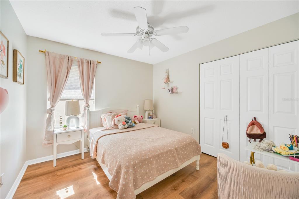 10318 Summerview Circle Riverview, FL 33578 - Photo 34 of 39 a bedroom with a bed and a chandelier