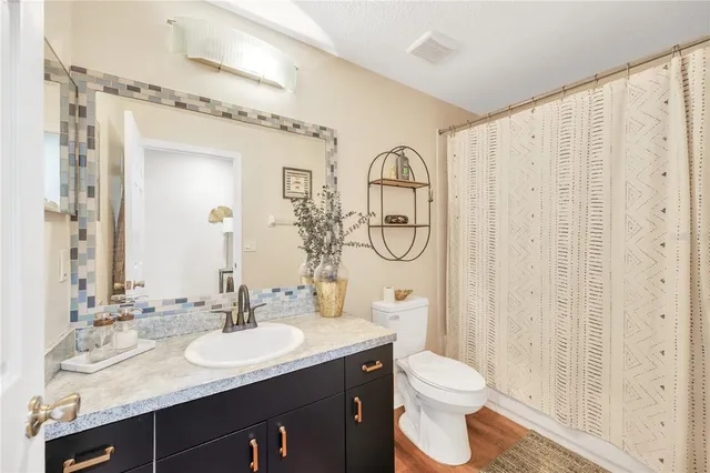 a bathroom with a double vanity sink toilet and shower
