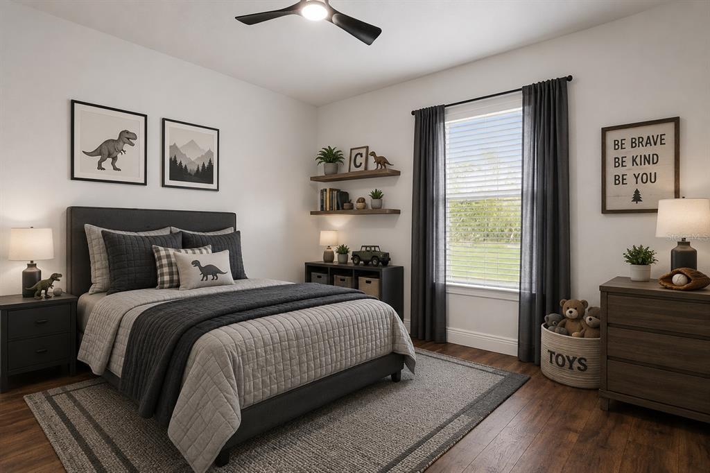 9412 Noddy Tern Road Weeki Wachee, FL 34613 - Photo 15 of 35 a bedroom with a bed and wooden floor