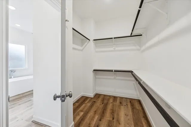 a view of a room with wooden floor